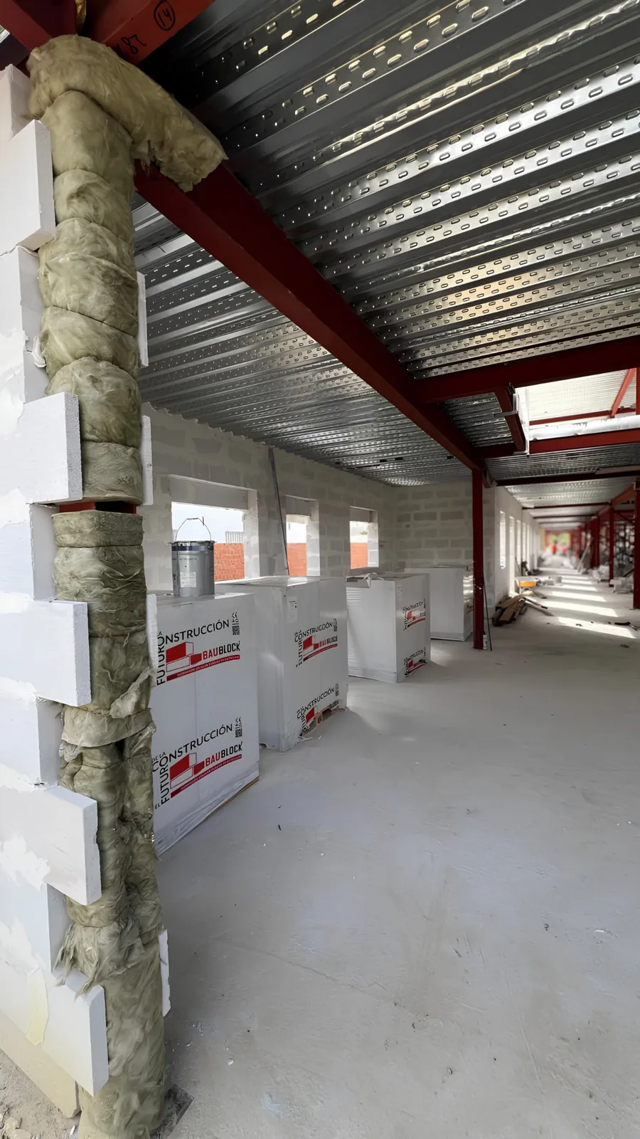 BAUBLOCK materials beside AAC wall construction and insulated structural interfaces during the build.