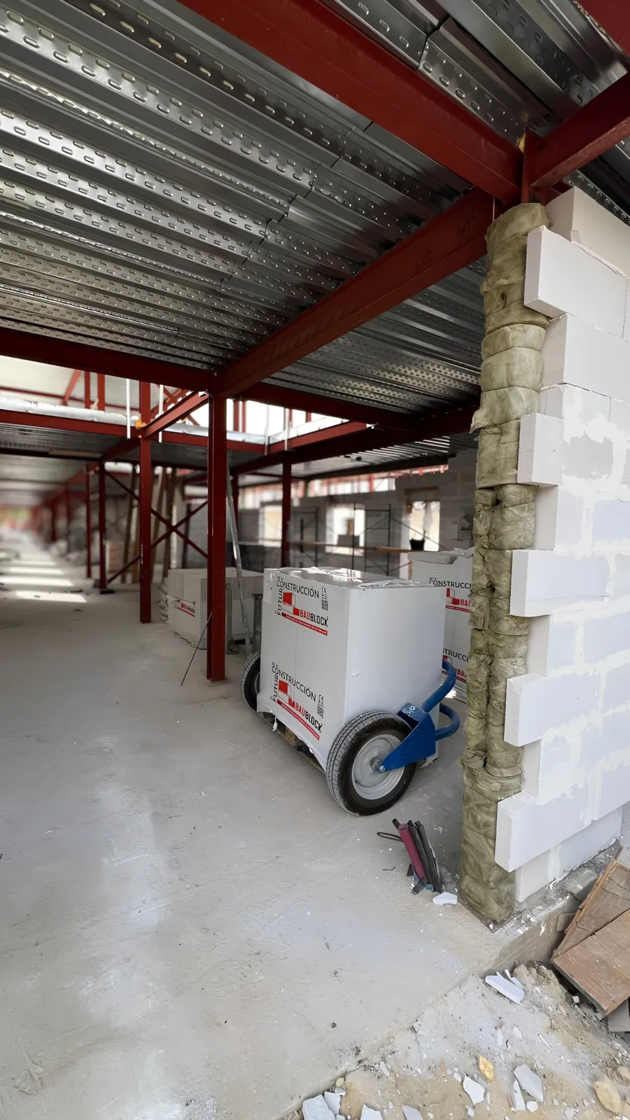 BAUBLOCK materials positioned within a structural steel frame on an active construction project.